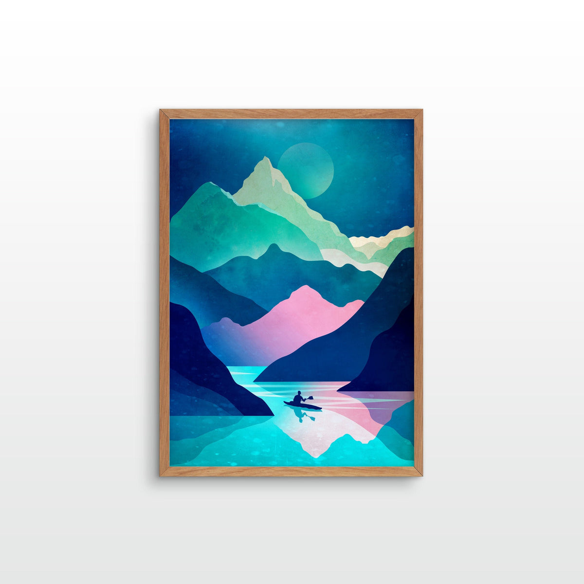 A framed art print featuring a stylized, geometric mountain landscape in shades of teal, blue, pink, and green, with a small silhouette of a person in a boat on the water, displayed against a clean white wall.