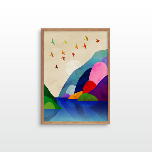 A framed abstract landscape art print featuring colorful geometric hills, birds, and water on a light beige background