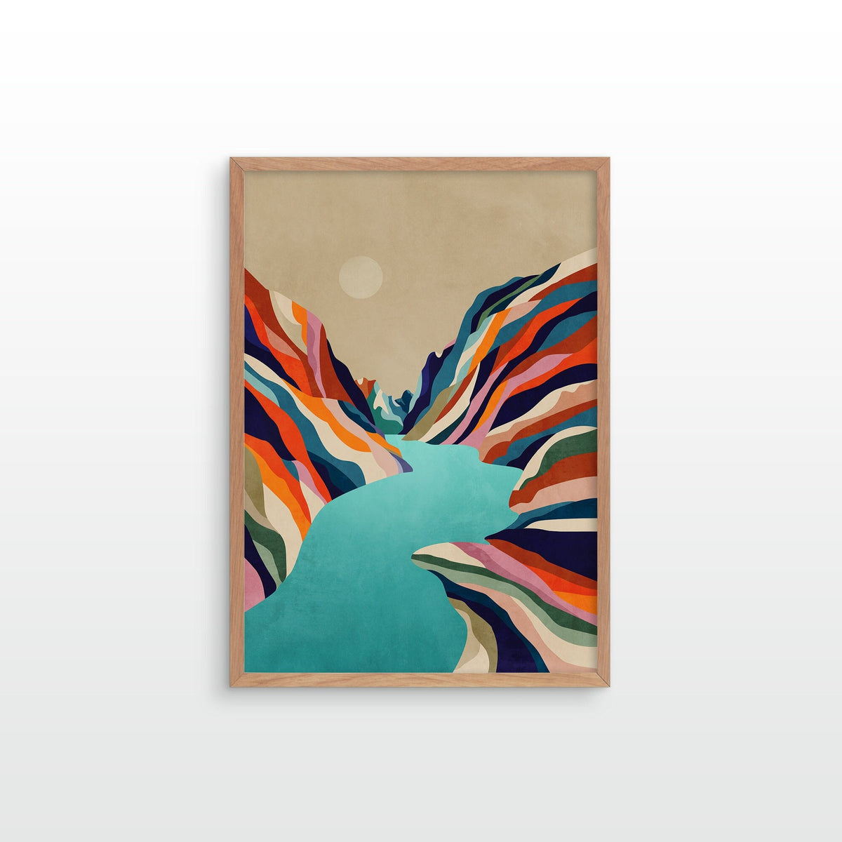 A framed art print featuring a stylized landscape with a turquoise river or valley cutting through multicolored striped mountains under a beige sky, displayed against a light gray wall.