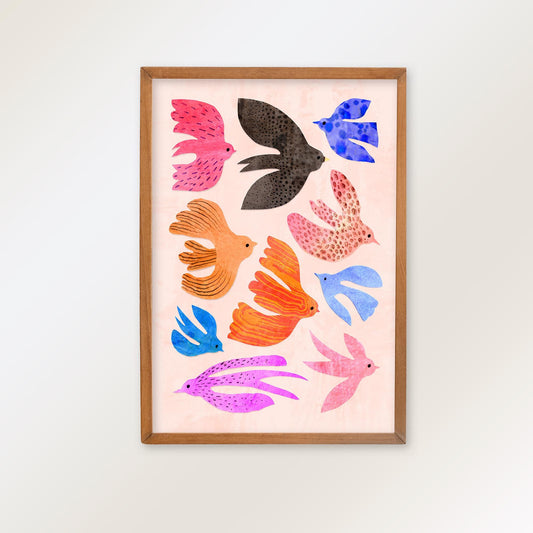 A framed art print featuring a collection of colorful, stylized birds in pink, blue, orange, purple, and black on a pale pink background