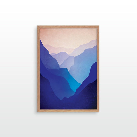 A framed art print featuring a minimalist mountain landscape with layered blue and purple peaks under a soft peach sky