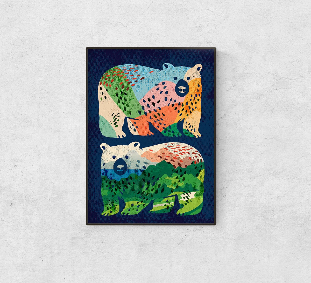 A framed art print featuring two stylized polar bears in a colorful, patterned design on a dark navy background, displayed on a light gray textured wall.