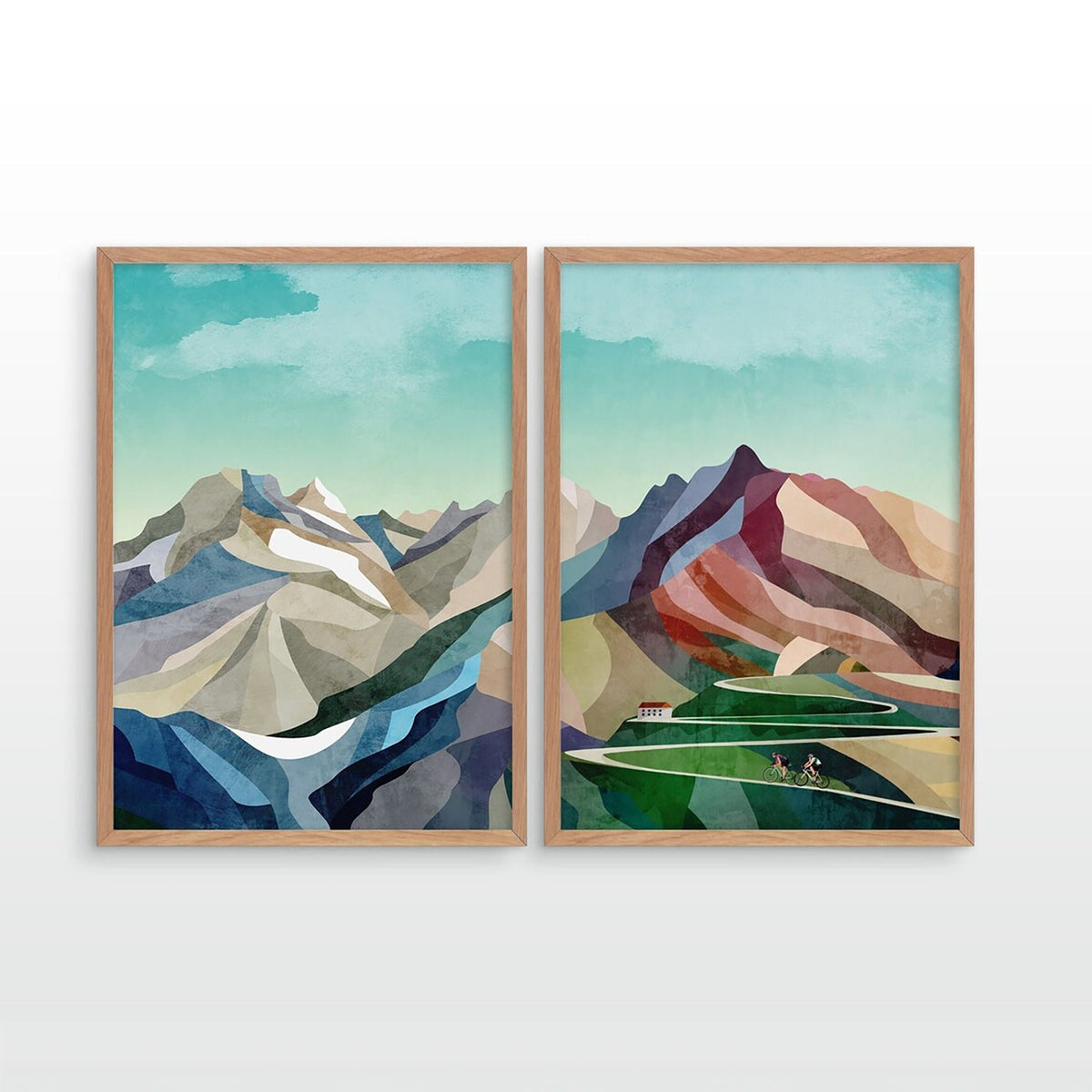 Two framed minimalist mountain landscape prints hanging side by side on a white wall. The artwork features stylized peaks in blue, gray, white, green, and terracotta tones under a pale teal sky.