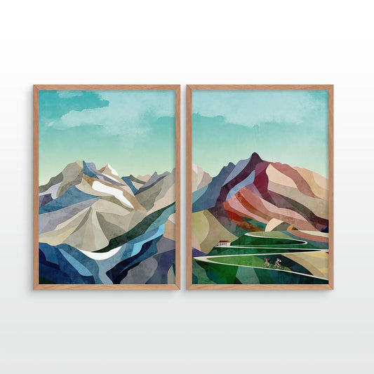 Two framed minimalist mountain landscape prints hanging side by side on a white wall. The artwork features stylized peaks in blue, gray, white, green, and terracotta tones under a pale teal sky.