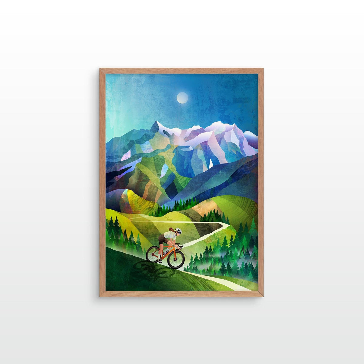 A framed art print featuring a stylized illustration of a cyclist riding through green mountains under a blue sky with a moon, displayed on a light gray wall.