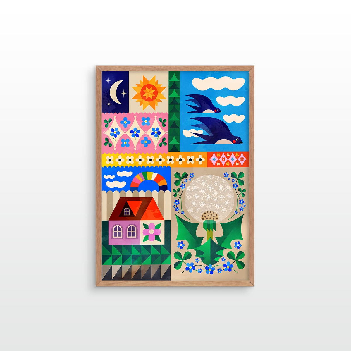 A framed folk art print featuring a colorful patchwork design with a crescent moon, sun, birds, flowers, a house, and a dandelion, displayed against a light gray wall.