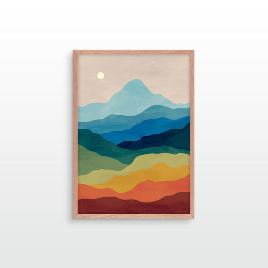 A framed minimalist landscape art print featuring layered blue mountains, green hills, yellow and orange fields, and a pale moon on a light beige background