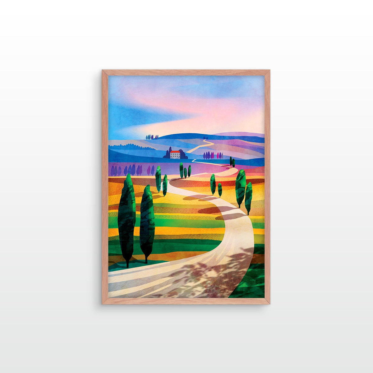 A framed art print depicting a stylized Tuscan landscape with a winding road, cypress trees, rolling hills, and a small house under a pastel sky, shown hanging on a light gray wall.