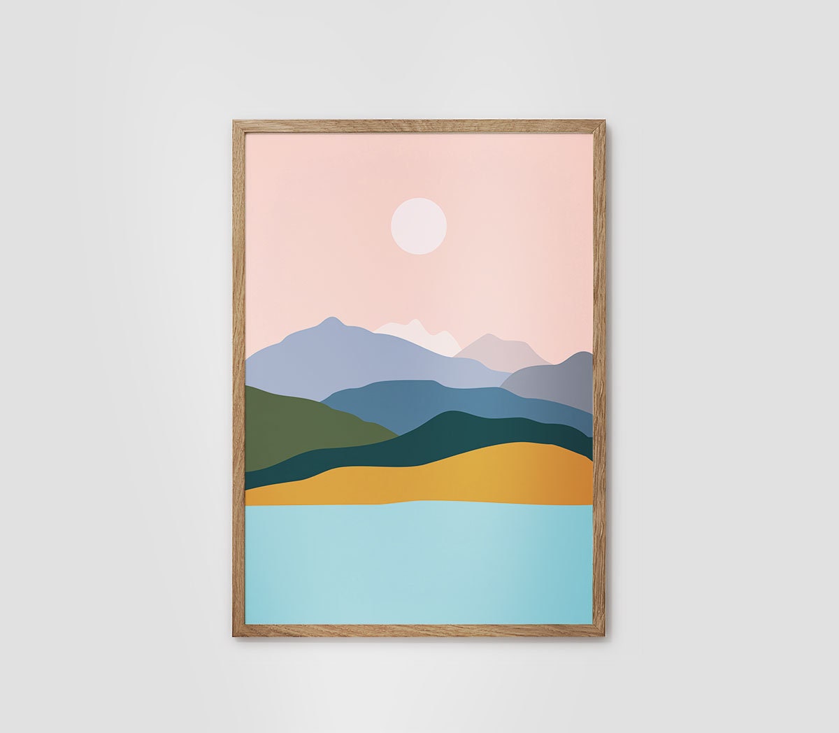 A framed minimalist landscape art print featuring stylized mountains, hills, and a lake in pastel colors under a pink sky with a white sun, set against a light gray background.