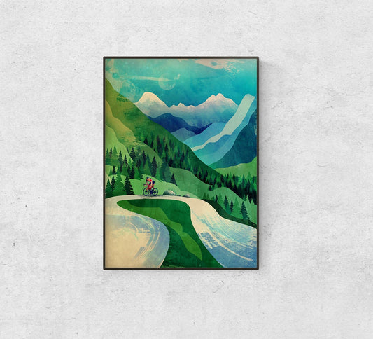 A framed art print depicting a scenic mountain landscape with a cyclist on a winding road