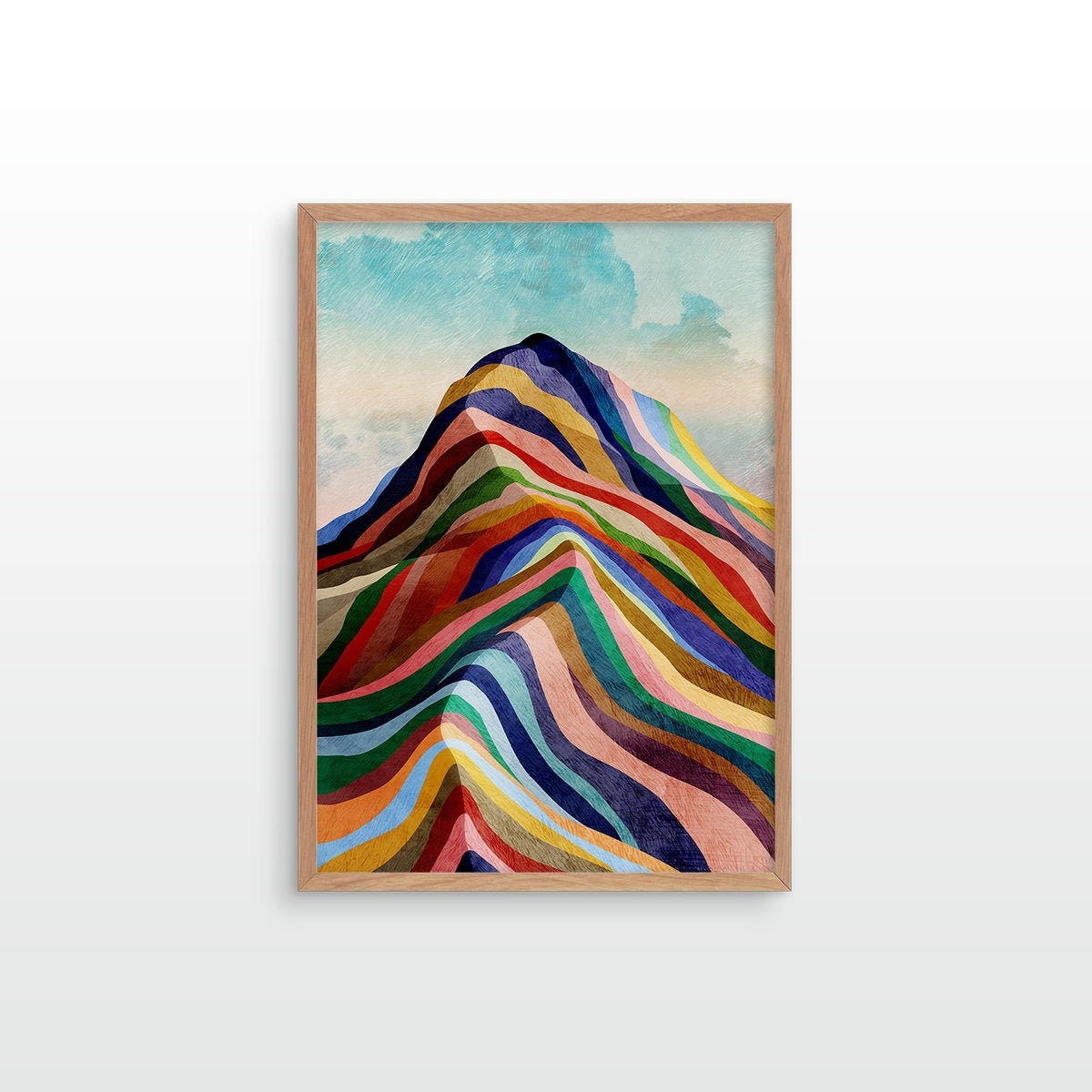 A framed art print featuring a colorful mountain illustration with layered rainbow stripes under a light blue sky