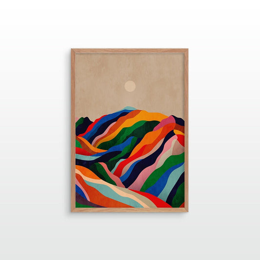 A framed art print featuring a colorful, abstract mountain landscape with wavy, layered peaks in red, orange, yellow, green, blue, and purple against a warm beige sky