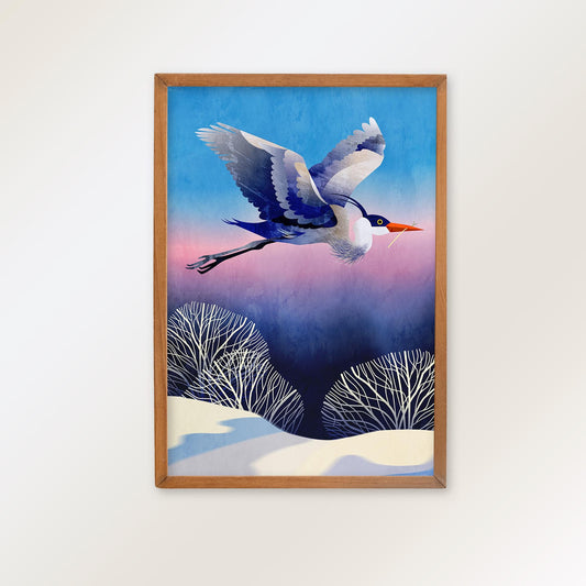 A framed art print featuring a flying bird in flight over a snowy landscape under a blue and pink sky, mounted on a light beige wall.